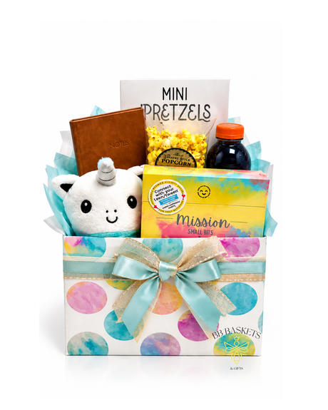 A Little Box of Happy Gift Basket with plush unicorn, Mission Small Bits activity cards, journal, mini pretzels, theatre-style popcorn and Gatorade in a colorful pastel gift box.