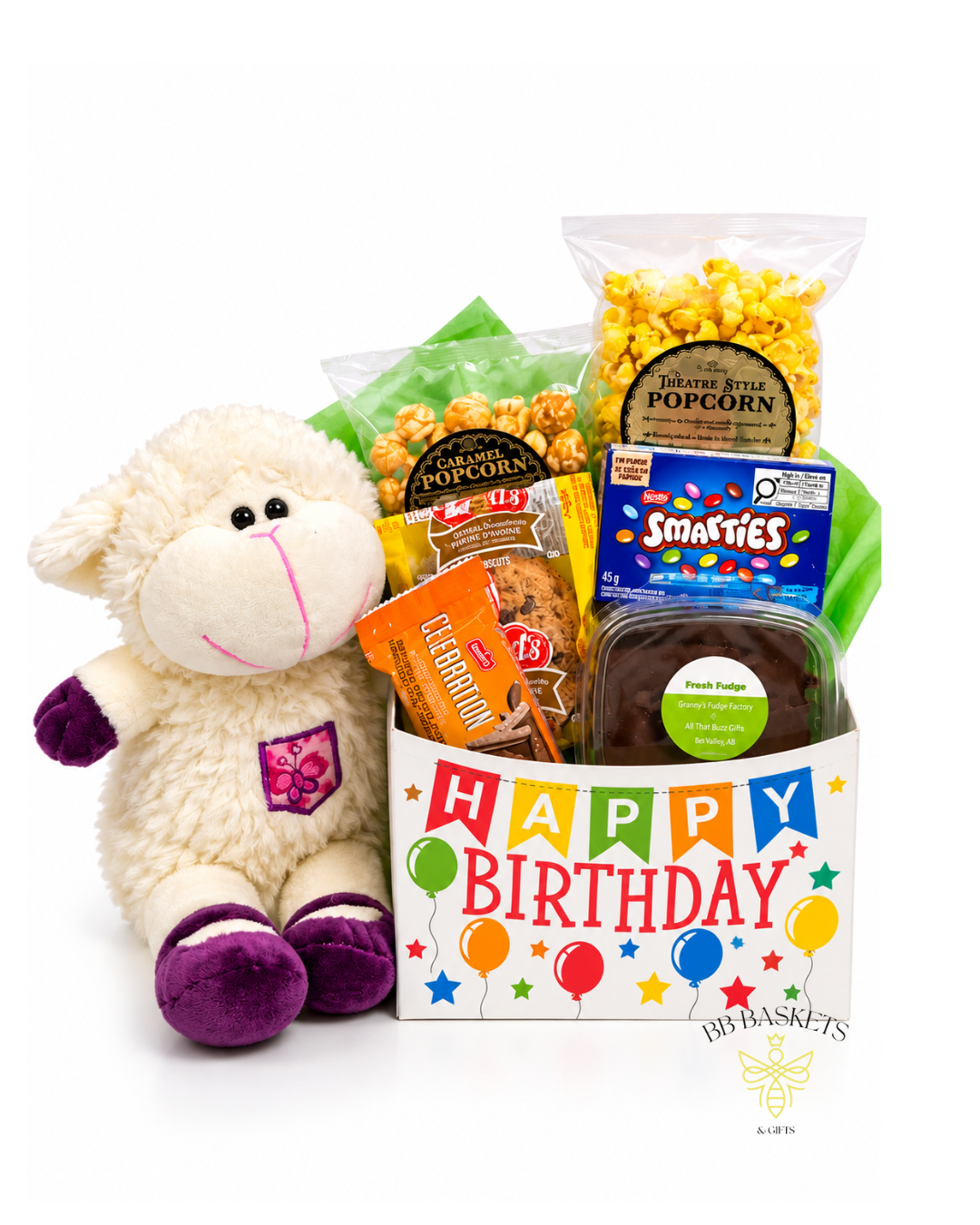 Birthday Wishes & Sweet Surprises Gift Basket featuring a plush lamb, Smarties, caramel popcorn, theatre-style popcorn, local fudge and cookies in a colorful Happy Birthday box.